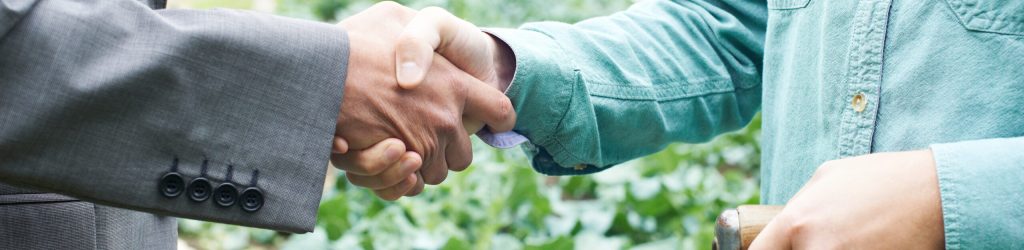 Farmer And Businessman Shaking Hands